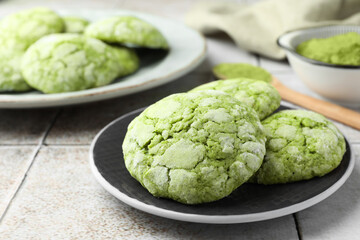 Tasty matcha cookies on tiled table, closeup