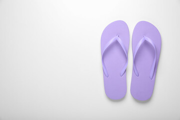 Stylish violet flip flops on white background, top view. Space for text