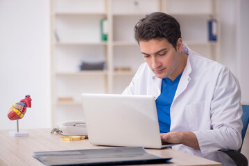 Fototapeta premium Young male doctor in telemedicine concept