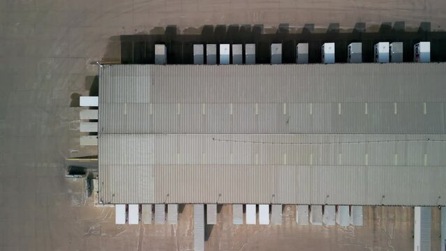 Above Aerial video a FedEx warehouse and many trailers near it. Naperville IL. USA 5 Feb 2023