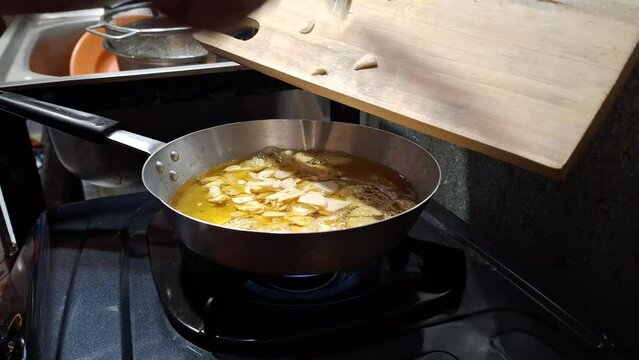 The activity of someone who likes cooking is frying garlic