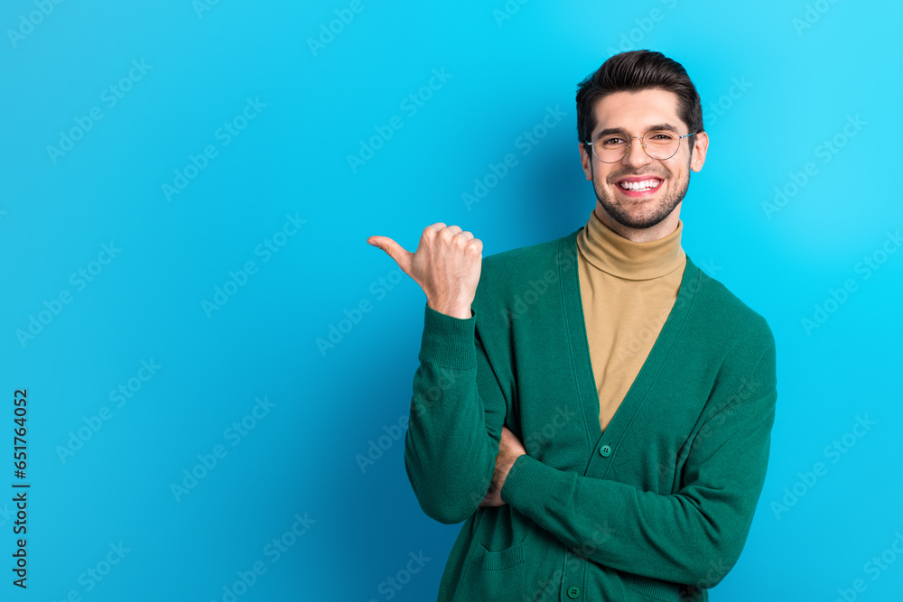 Poster Photo of positive attorney man toothy smile direct thumb finger empty space ad isolated on blue color background