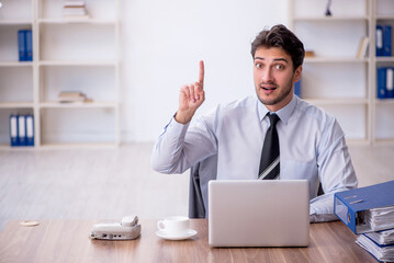 Young male employee working in the office