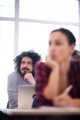 Students listening to a lecturer in a classroom. Smart young people study at a college.