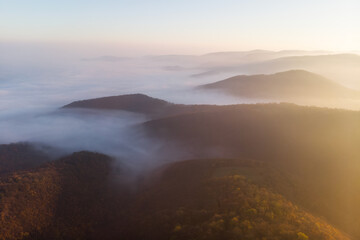 Majestic sunrise over misty mountain range