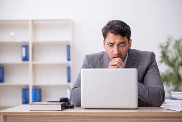 Young male employee working in the office