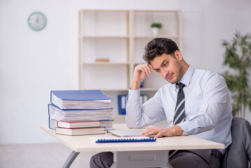 Fototapeta premium Young male employee working in the office