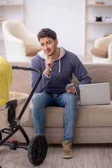 Young man looking after newborn at home