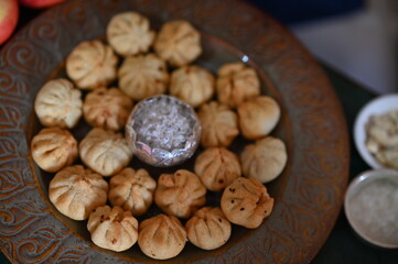 Beautiful Plate with the fried Modak. Sweets for Lord Ganesha. Silver Bowl with coconut and sugar. Prasad for Lord Ganesha. Chaturthi festival Chaturdashi festival Visarjan Pooja of lord Ganesha 