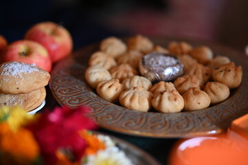 Fruits and plate with fried Modak. Favorite sweets of the Lord Ganesha. Silver Bowl with coconut and sugar. Ganesha festival, chaturthi, visarjan, Chaturdashi. 