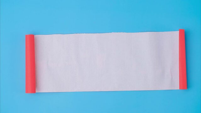 An orange rolled square paper is spread out into a blank white sheet on a light blue background. Crumpled blank white paper with copy space for text or advertising space.