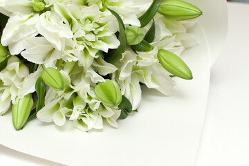 White lilies on a old wooden background. lilies on a white background.