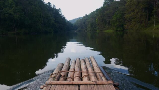 POV on a bamboo rafting boat on a lake in Thailand