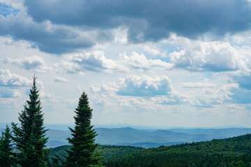 panoramic view of the forest and mountains in cloudy sky in New England