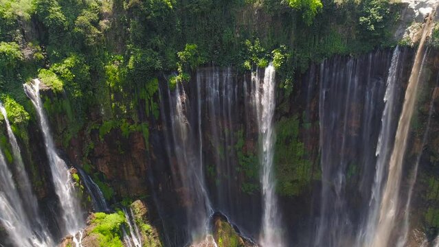 aerial view waterfall coban sewu in Java, indonesia. waterfall in tropical forest by drone Tumpak Sewu aerial footage