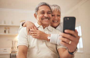 Senior couple, home and smile with smartphone for video call, mobile streaming and scroll on social media in retirement. Happy old man, woman and hug with phone for selfie, reading news app and relax