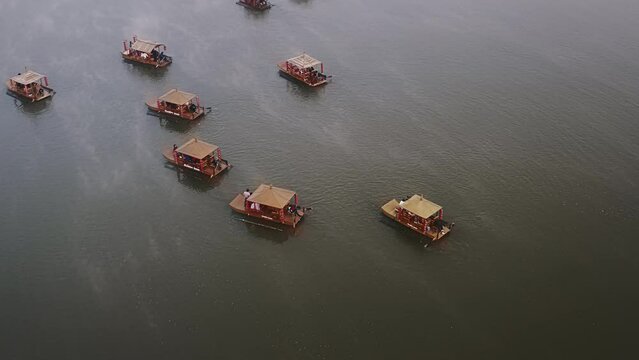 Aerial shot over Asian chinese boat with mist on a lake in Thailand