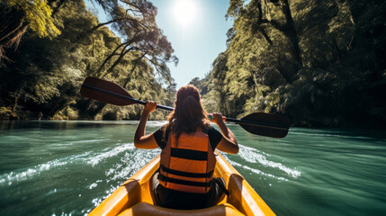 Woman kayaking on a calm river enjoying the landscape. - obrazy, fototapety, plakaty