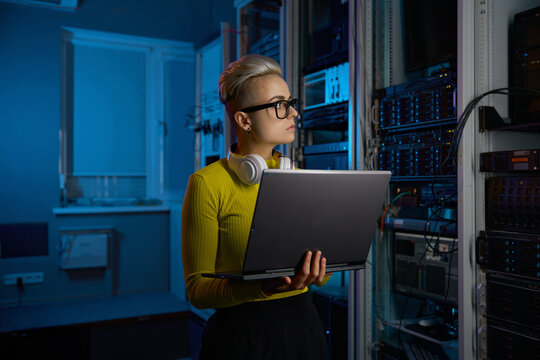 Portrait of concentrated woman coder solving problem in data center