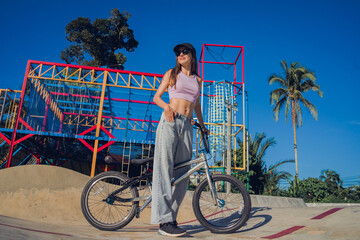 Happy young woman enjoy BMX riding at the skatepark