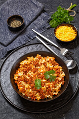 Lasagnette bolognese in black bowl, top view