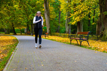 Fototapeta premium Healthy lifestyle - woman running in city park 
