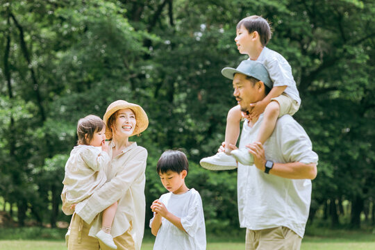 公園の中を歩く5人家族・親子・ファミリー（抱っこ・肩車・帰省・旅行・里帰り）
