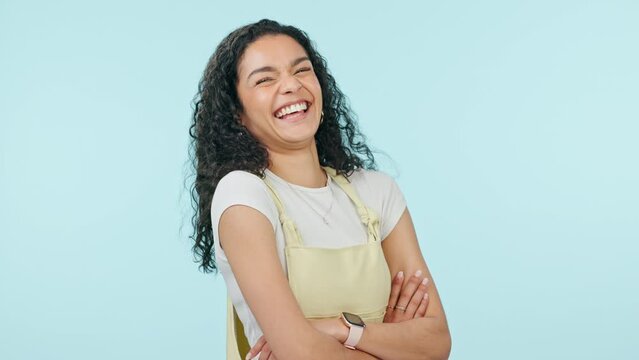 Arms crossed, face and a laughing woman on a studio background for positive attitude and a joke. Happy, young and portrait of a girl or person with confidence, comedy and funny youth or teen