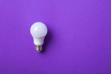 White lightbulb on purple background.