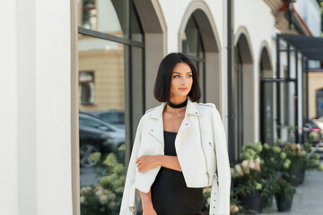 Beautiful young fashionable girl model with a short brunette hairstyle in a fashion elegant black...