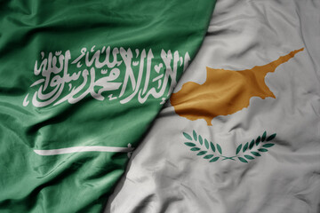 big waving realistic national colorful flag of saudi arabia and national flag of cyprus .