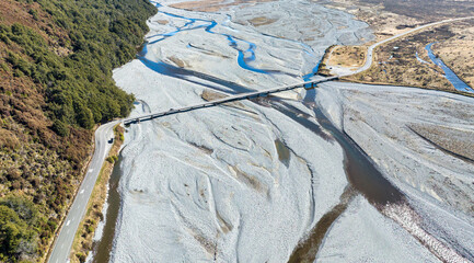 Aerial photography of the braided river with very little water flowing through the alpine Arthurs...