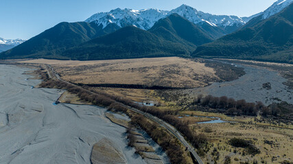Aerial photography of the braided river with very little water flowing through the alpine Arthurs Pass