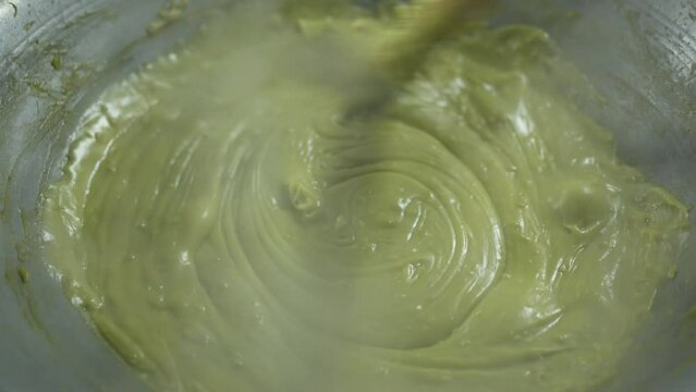 cooking liquid rhombic pandan leaf stirring or closeup freshly kanom piak poon bai toey and green coconut sweet pudding with smoke steam heat on hot pan charcoal stove to thailand nature dessert food