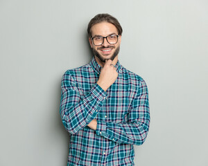 Fototapeta premium confident happy man with glasses folding arms, smiling and dreaming