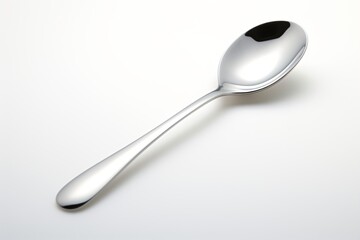 Silver spoon isolated on a grey background