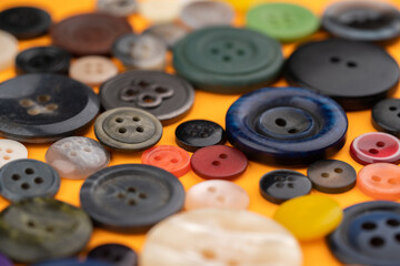 Many different buttons on a yellow background - obrazy, fototapety, plakaty