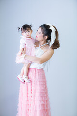 Fototapeta na wymiar Portrait of Asian mother and child on background,