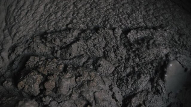 Concrete is mixed in a close up concrete mixer