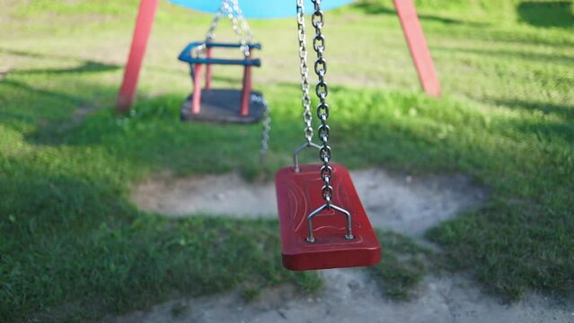 Playground swing set. Children swing in the park. High quality FullHD footage