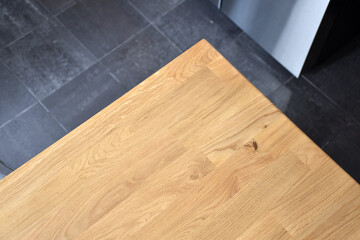 Empty wooden table with black tiled floor