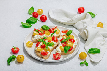 Fresh bread sandwiches with tomato cherry, cream cheese and basil leaves. Morning breakfast concept