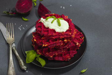 Homemade beetroot Belgian waffles with sauce. Gluten free vegan food with vegetables
