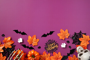 Halloween holiday background with decorations, maple leaves, bats, pumpkins, skeleton hands, skull,...