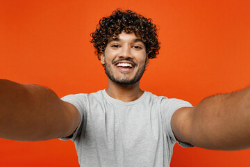 Close up young smiling satisfied happy Indian man he wears t-shirt casual clothes doing selfie shot...