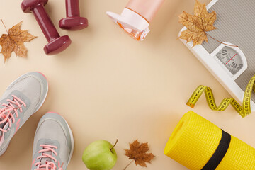 Autumnal body change concept. Top view photo of karemat, sneakers, floor scales, tape measure, dumbbells, water bottle, fresh apple, dry maple leaves on pastel beige background with ad zone