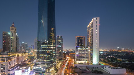 Obraz premium Dubai International Financial district aerial day to night. Panoramic view of business and financial office towers.