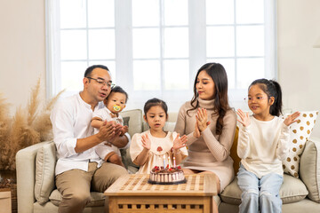 Portrait of happy love asian big family father and mother with asian baby and little girl happy birthday, party, celebration, cake, surprise together.Family party