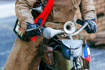 close up of a driver of a old belt drive motorcycle ca 1903 with leather gloves and Old-fashioned...