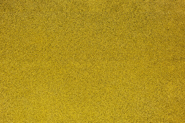 Grainy yellow texture made of rubber tiles